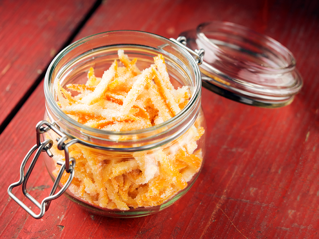 An image of some candied citrus peels in a glass jar