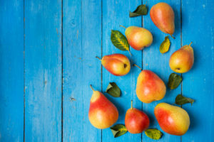 Forelle pears on a blue wooden background.
