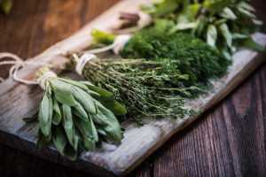 Fresh herbs on a wooden cutting board