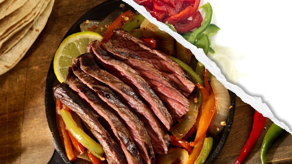 Slices steak fajitas with peppers and onions, featuring raw bell pepper slices. 