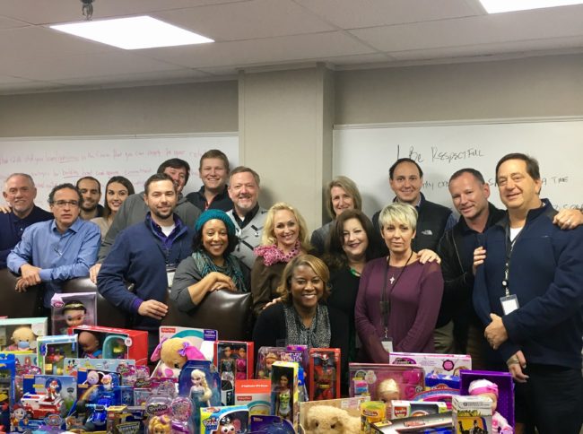 FreshPoint Dallas' sales team with part of the holiday donations for The Family Place.