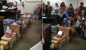 FreshPoint Dallas' retail team having fun with their train display of 99 toys donated to The Family Place.