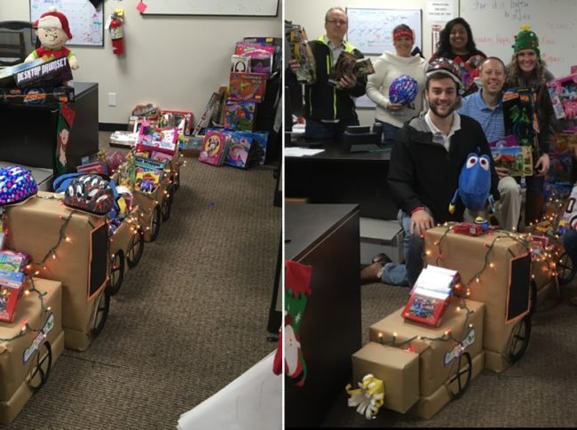 FreshPoint Dallas' retail team having fun with their holiday train display of 99 toys donated to The Family Place.